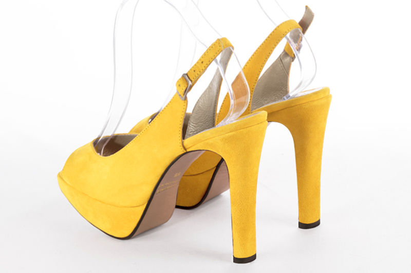 Yellow women's slingback sandals. Round toe. Very high slim heel with a platform at the front. Rear view - Florence KOOIJMAN